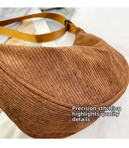 Close-up of the precise stitching and corduroy texture on this brown crossbody bag