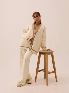 Chic two-piece knit set featuring V-neck cardigan and loose trousers in cream and beige