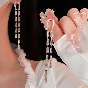 U-shaped long tassel earrings with sparkling zircon crystals in elegant gold finish