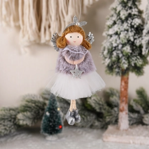 Plush Christmas tree angel ornament with silver wings and a star in a winter scene