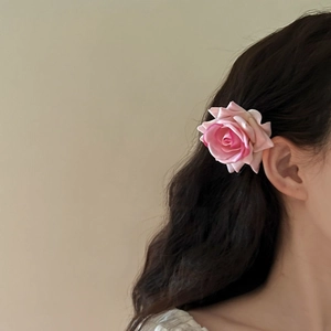 French retro style pink rose hair clip accessory worn by a model on hair side
