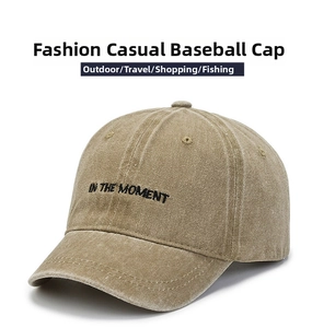 Close-up of retro khaki washed cotton baseball cap with 'IN THE MOMENT' black embroidery