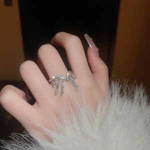 Elegant silver tassel ring with sparkling zircons worn on finger for a luxury fashion look
