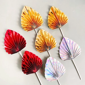 Shiny paper folding fan cake toppers in gold, red and holographic silver for party decor