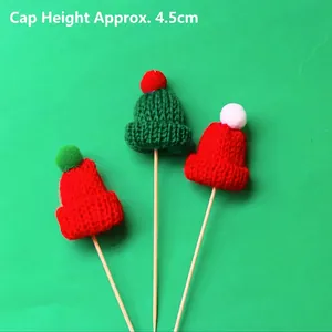 Miniature knitted Christmas hat cake toppers in red and green, 4.5cm height detail