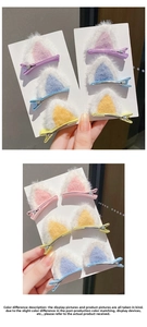 Close-up of plush cat ear hair clips in assorted macaron colors with metal alligator grips