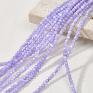 Macro detail of 3mm purple natural freshwater shell beads for DIY jewelry making
