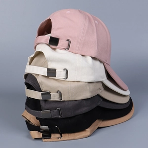 Close-up of cotton baseball caps showing adjustable metal buckles and color variety