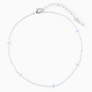 Close-up of silver anklet featuring five light blue flower beads and a lobster clasp