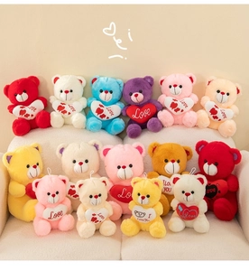 Group of colorful teddy bears with heart pillows arranged neatly on a beige sofa