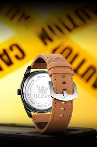Detail of chronograph watch back with stainless steel case and brown leather strap texture