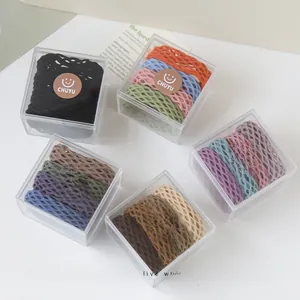 Detail of multi-color elastic hair ties with mesh texture in transparent gift boxes