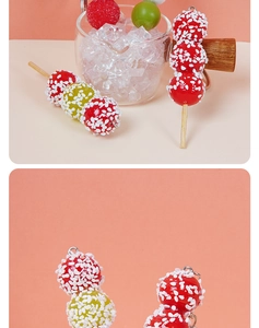 Detailed view of red and green miniature candied hawthorn charm with sesame texture and hook
