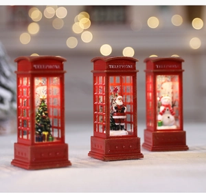 Three illuminated red Christmas telephone booths with Santa Claus and snowmen details