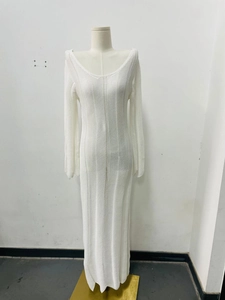 Detail of white V-neck knitted dress showing long flared sleeves and hollow out texture