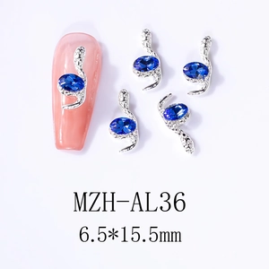 Macro view of silver snake-shaped nail art charms with blue oval gems, size 6.5x15.5mm