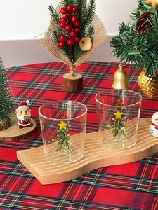 Detailed macro view of 3D green Christmas tree inside a clear borosilicate glass cup