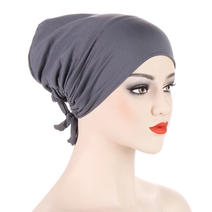Detail view of the pleated back design and knot on a dark grey turban undercap