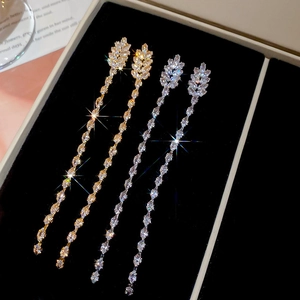 Detailed view of 18K gold plated tassel earrings with zircons in a premium jewelry box