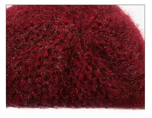 Close-up of seamless crown stitching on thick wine red plush knitted winter hat for elderly women