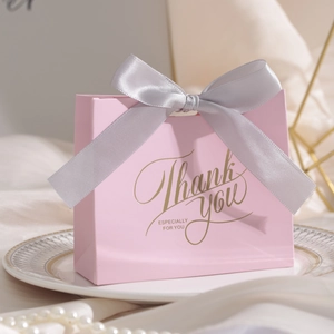 Detail of pink wedding gift bag with silver-grey ribbon and gold foil Thank You text