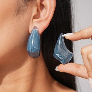Deep blue irregular geometric resin stud earrings with marble texture and gold powder flecks