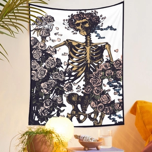 Detailed wall hanging tapestry featuring skeleton and roses in a cozy room setting