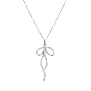 Detail shot of a silver bow necklace featuring a ribbon-style pendant and a delicate O-chain