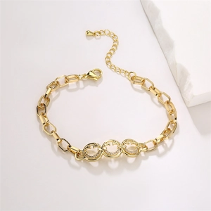 Detail of gold hip-hop chain bracelet featuring zircon smiley faces and lightning charms