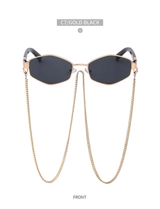 Close-up of gold hexagonal metal frame sunglasses with decorative side chains