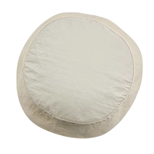 Close-up of beige bucket hat featuring a flat top design and detailed stitching lines