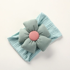 Close-up of light blue knitted nylon baby headband with large sage green fabric flower