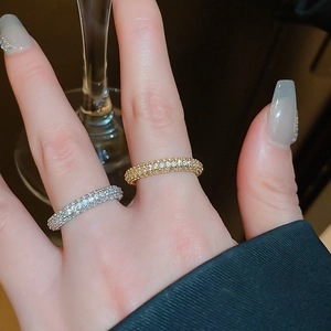 Close-up of thin gold and silver stackable rings with micro-pave cubic zirconia stones