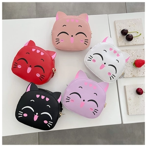 Flat lay of colorful cartoon cat mini shoulder bags in pink red white black and purple