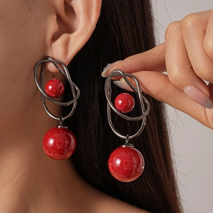 Geometric acrylic drop earrings with red round beads and dark metal wire design
