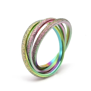 Frosted rainbow stainless steel interlocking triple band ring on white background