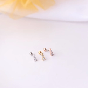 Three minimalist triangular dangle stud earrings in silver, gold and rose gold colors