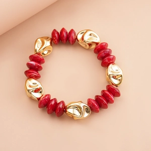 Detail view of vintage red marble acrylic beads and irregular gold metal beads on bracelet