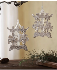 Detail of silver carousel Christmas pendants with glitter hanging on pine branches