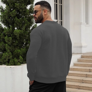 Slim fit men's dark grey cable knit cardigan sweater with ribbed cuffs shown from the back