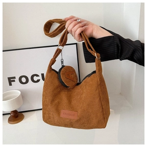 Detail of brown corduroy shoulder bag with FASHION label and small round A-letter purse
