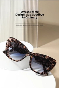 Close-up of cat-eye sunglasses with leopard print acetate frame and gradient lenses