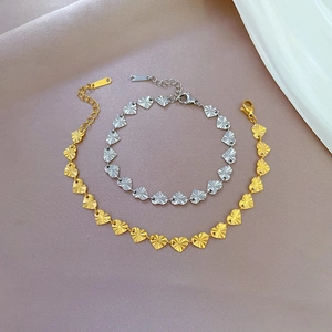 Elegant gold and silver S925 sterling silver heart chain bracelets on soft fabric