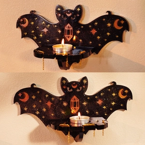 Gothic bat-shaped wall shelf for candles with moon and star details and gold chains