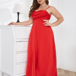 Detail of red satin maxi dress featuring side cut-outs and elegant backless design