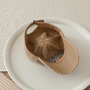Macro shot of khaki cotton baseball cap with distressed brim and Portland embroidery
