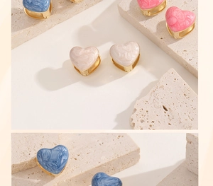 Detailed shot of double heart earrings with blue pink and beige marble patterns