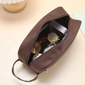 Detail view of large brown PU leather wash bag with zipper and spacious interior