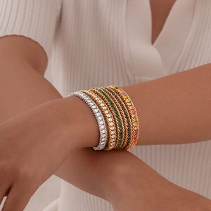 Stackable gold and silver tennis bracelets with multicolor zircon stones on wrist