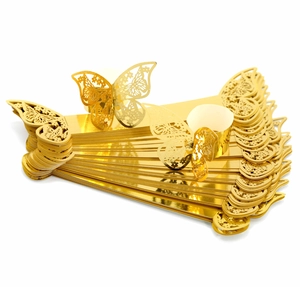 Detail of laser-cut gold butterfly napkin rings for wedding and party table decor